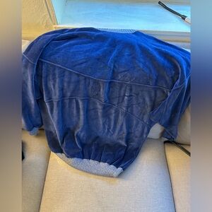 Blue European sweater with a small stain